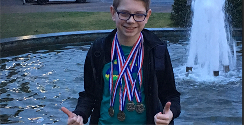 Learn to Swim teacher Nathan McKechnie Learn to Swim instructor Nathan McKechnie with his medals as a young child