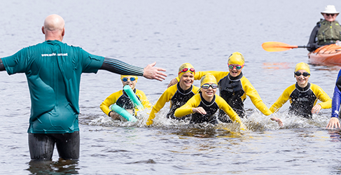 Learn to Swim School Swimming Safety Lesson children and instruction in open water at Loch Lomond learning safety skills during Drowning Prevention Week