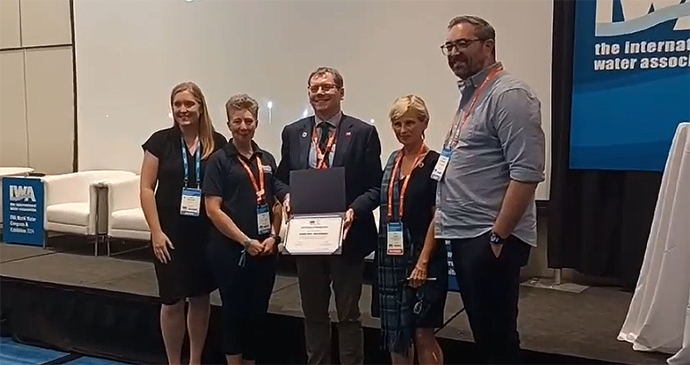 Scottish Water IWA Award Scottish Water CEO Alex Plant, pictured with four IWA representatives, receives award from climate work at IWA Word Water Congress