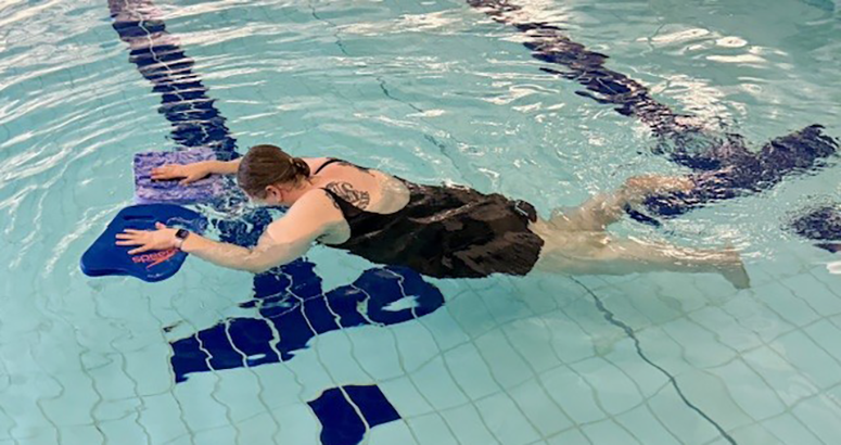 Learn to Swim Laura McLeod Laura McLeod floating face down in swimming pool with hand float aids