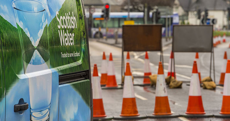 Generic Roadworks image Back of a Scottish Water van next to road traffic cones and signage